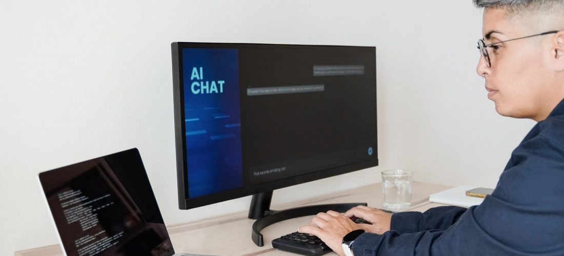 AI chatbot: Programmer using artificial intelligence for software development inside office - Virtual chat Bot technology trend - Focus on hands