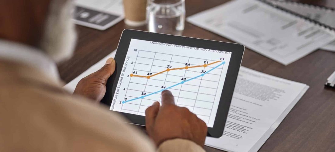 hand-of-man-in-meeting-with-tablet-charts-and-gra-2023-11-27-05-01-34-utc-min